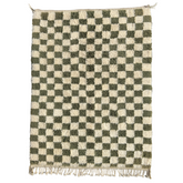 Introducing Petite Olive, a charming small-sized area rug featuring a classic checkers design that seamlessly complements various home settings.
